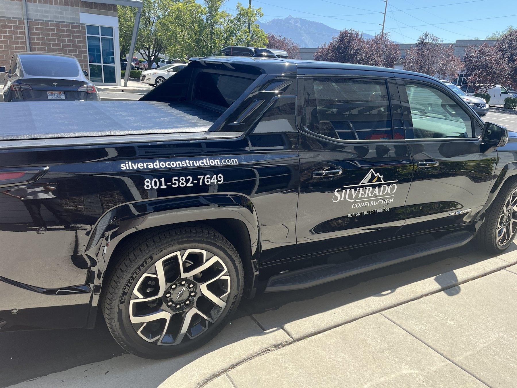 Vinyl lettering and logo decals installed on a Silverado Construction truck